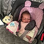 baby, sleeping, car_seat, pink, teddy_bear, plush, blanket, infant, child, seat_belt, soft, cozy, cute, rest, peaceful, indoors, fabric, comfort, head_support, small_hand
