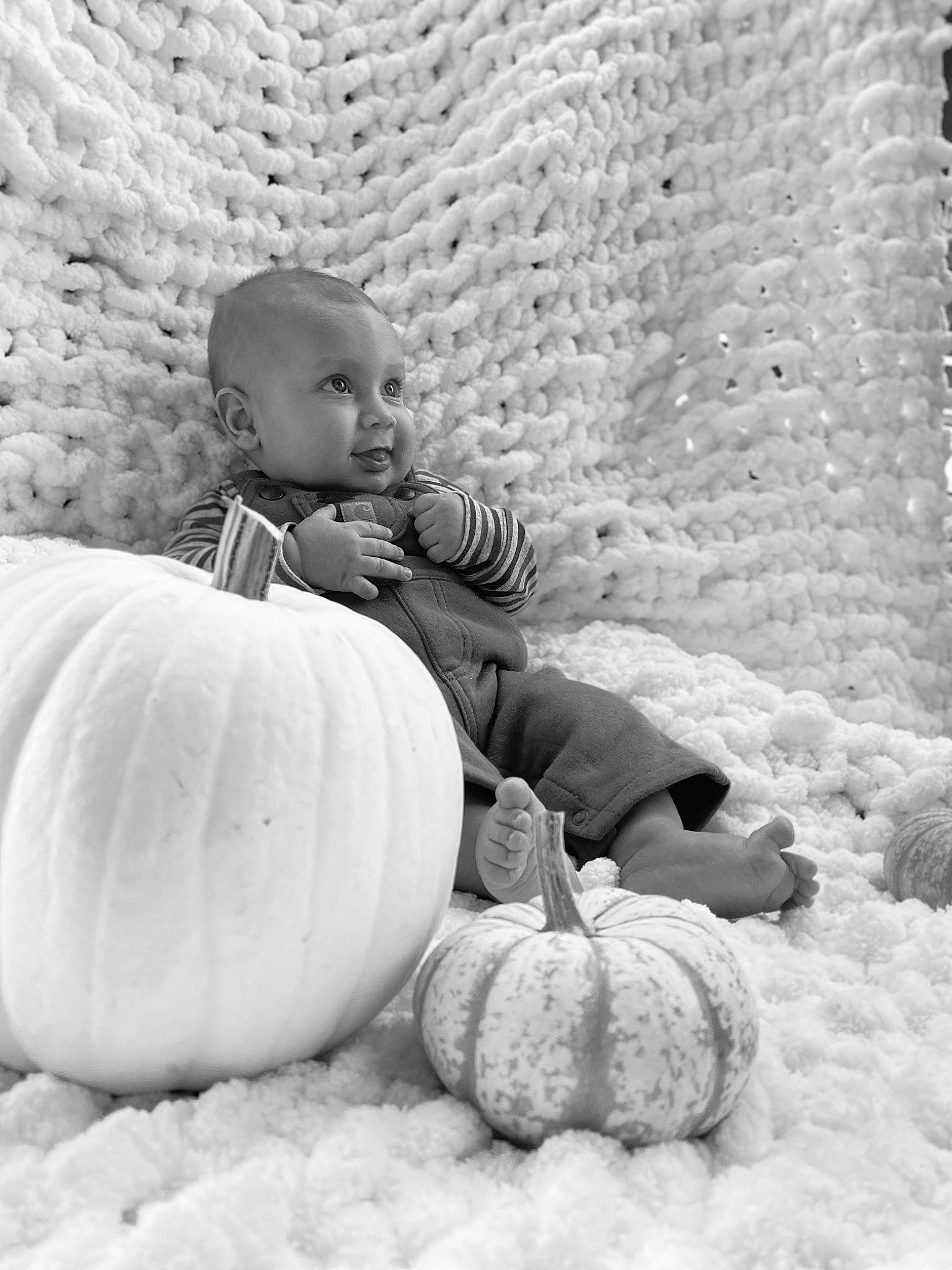 Legend is registered to the contest to win money with this photo: baby, black_and_white, calabaza, child, cucurbita, eye, monochrome, monochrome_photography, person, photograph, photography, plant, play, pumpkin, sitting, smile, stock_photography, toddler, vegetable, white