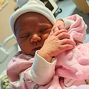Giulianna is registered to the contest to win money with this photo: baby, newborn, sleeping, infant, pink_blanket, hat, hand, cute, cozy, soft, hospital, closeup, peaceful, child, person, wrapped, warm, face, tiny_hands, indoors