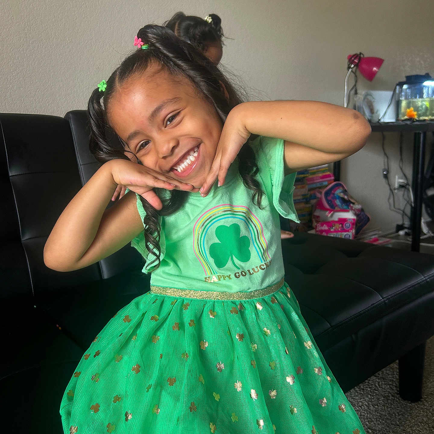 Malieah is registered to the contest to win money with this photo: black_sofa, books, carpet, child, curly_hair, cute, decor, fish_tank, furniture, girl, green_dress, happy, indoor, lamp, living_room, playful, portrait, posing, smiling, toys