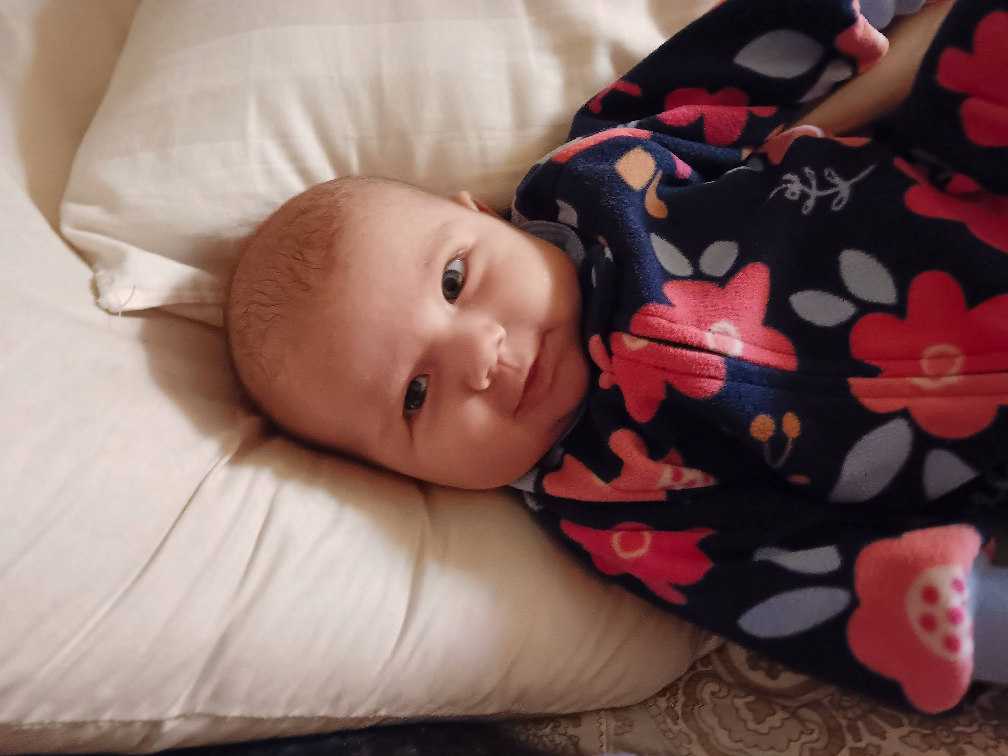 Katie is registered to the contest to win money with this photo: baby, baby_toddler_clothing, cheek, child, comfort, flooring, linens, pattern, person, portrait_photography, room, sitting, skin, sleeve, textile, toddler, tree, wood