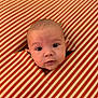 baby, child, closeup, curious, cute, expression, eyes, face, head, hole, indoor, infant, orange, pattern, peek, portrait, soft_light, striped_fabric, white, young