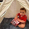 Louis joined the competition — help win amazing prizes! baby, blanket, box, carpet, casual, child, curious, cute, floor, home, indoor, play, red_clothing, sitting, soft_lighting, teepee, tent, toddler, toy, young_child