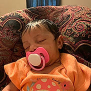 Emmy Levangie joined the competition — help win amazing prizes! baby, sleeping, pacifier, orange_shirt, mushroom_design, patterned_cushion, indoor, child, infant, peaceful, cute, face, person, clothing, resting, head, portrait, young, cozy, comfort