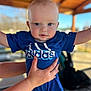 Justen is registered to the contest to win money with this photo: baby, child, blue_clothing, adidas, outdoor, daylight, hands, holding, pavilion, portrait, cute, face, smile, short_hair, person, infant, toddler, expression, skin, casual