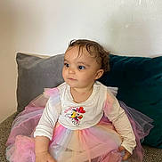 Jannah participe au concours pour gagner de l'argent avec cette photo : child, clothing, colorful_dress, couch, curly_hair, cute, expression, girl, indoor, looking_away, minnie_mouse, pastel_colors, pillows, portrait, sitting, soft_lighting, toddler, tutu, white_top, young_child