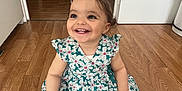 Jannah a rejoint le concours — aidez-le/la à gagner de superbes lots ! barefoot, bench, child, clothing, cushion, cute, dress, face, floral_pattern, hairclip, happy, home, indoor, person, room, sitting, smile, toddler, wooden_floor, young_child