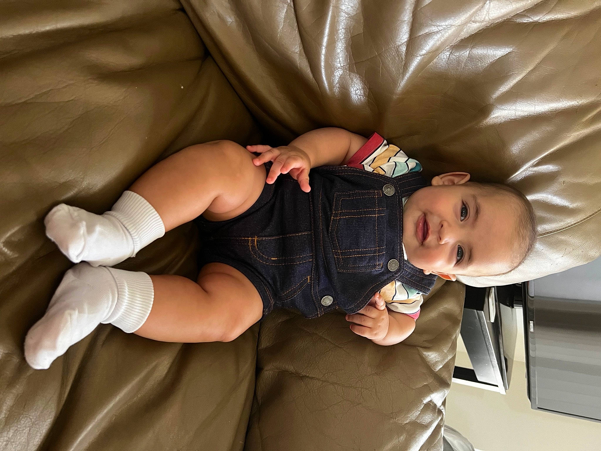 Juan joined the competition — help win amazing prizes! baby, baby_toddler_clothing, child, comfort, couch, elbow, finger, gesture, happy, human_leg, knee, lap, person, sitting, skin, sleeve, smile, sneakers, thigh, toddler