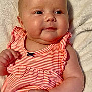 Lainey Dawn is registered to the contest to win money with this photo: baby, infant, child, cute, smile, dress, striped_clothing, pink, white_blanket, fluffy, portrait, closeup, cheeks, hand, soft_texture, indoors, resting, happy, healthy, young