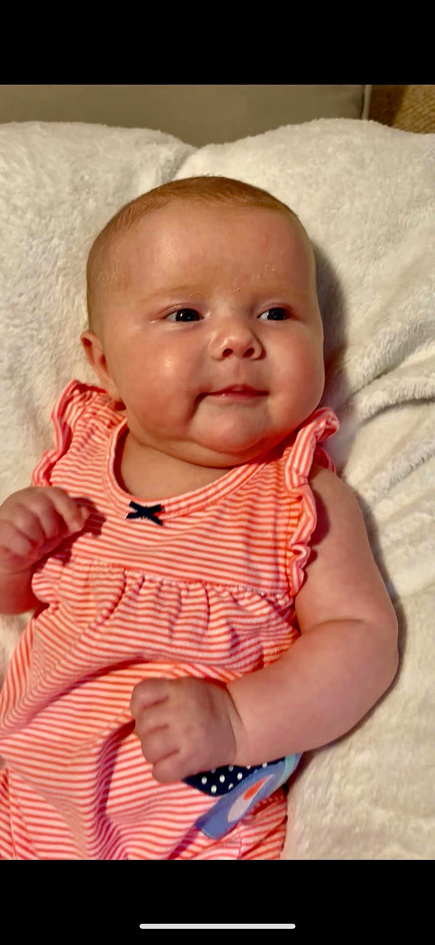 Lainey Dawn is registered to the contest to win money with this photo: baby, infant, child, cute, smile, dress, striped_clothing, pink, white_blanket, fluffy, portrait, closeup, cheeks, hand, soft_texture, indoors, resting, happy, healthy, young