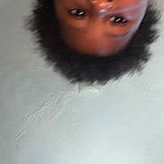 Azari joined the competition — help win amazing prizes! child, face, upside_down, blurry, close_up, curly_hair, indoor, ceiling, texture, portrait, expression, person, head, young, casual, skin, eyebrows, eyes, background, unfocused