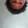 child, face, upside_down, blurry, close_up, curly_hair, indoor, ceiling, texture, portrait, expression, person, head, young, casual, skin, eyebrows, eyes, background, unfocused