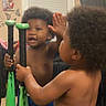 Azari joined the competition — help win amazing prizes! toddler, child, mirror, baseball_bats, reflection, curly_hair, shirtless, blue_shorts, indoor, window, blinds, wall_decor, butterfly, hand, high_five, playful, person, young_child, home, room