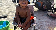 Azari joined the competition — help win amazing prizes! toddler, beach, sand, chair, hat, bucket, toys, towel, sunny, smiling, child, outdoor, summer, vacation, happy, barefoot, baby, play, relax, sunshade