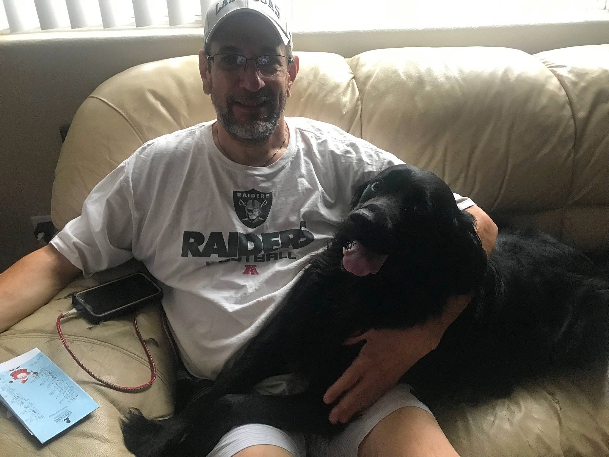 Colby is registered to the contest to win money with this photo: carnivore, comfort, companion_dog, cool, couch, dog, dog_breed, elbow, eyewear, fun, goggles, human_leg, knee, lap, shorts, sitting, smile, sunglasses, t_shirt, thigh
