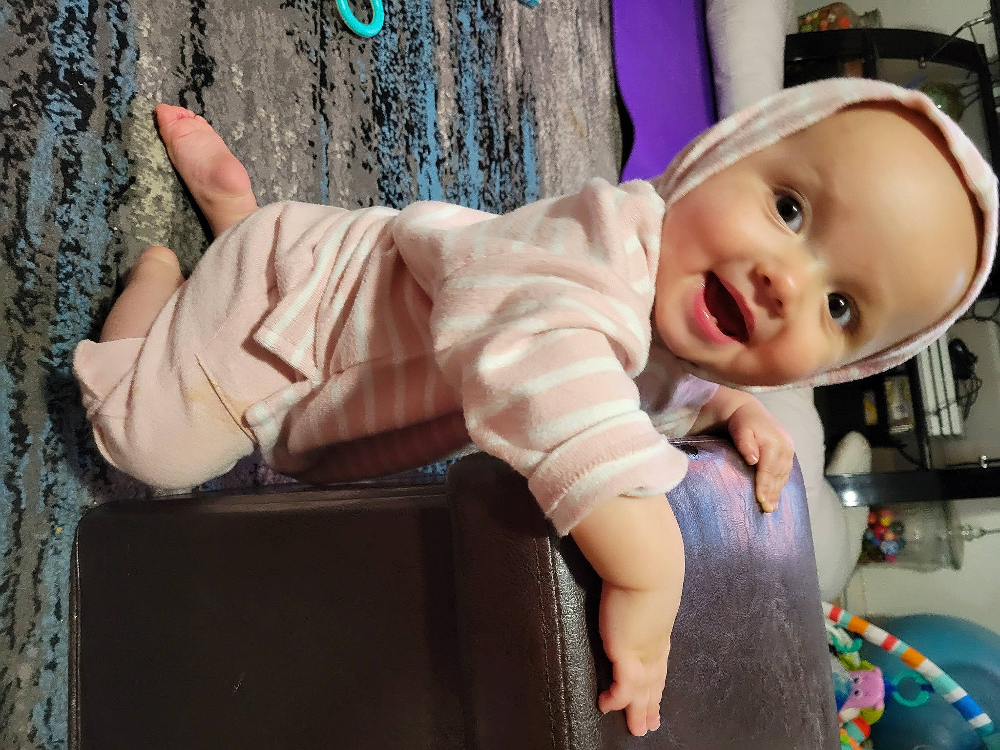 Elora is registered to the contest to win money with this photo: arm, baby, baby_products, baby_toddler_clothing, cheek, child, dress, fashion_accessory, fun, happy, hat, person, sitting, skin, sleeve, smile, t_shirt, thumb, toddler, tree
