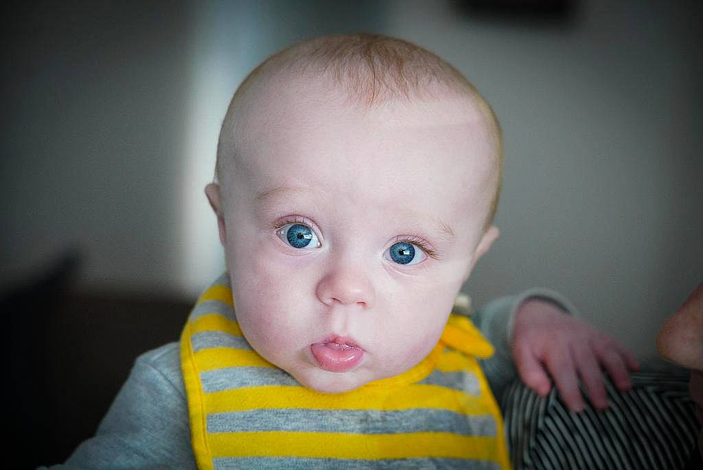 Ledger is registered to the contest to win money with this photo: baby, baby_toddler_clothing, cheek, child, ear, eyelash, finger, flash_photography, happy, iris, lip, mouth, neck, nose, person, sitting, skin, sleeve, thumb, toddler