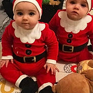 Chems Et Waël participe au concours pour gagner de l'argent avec cette photo : babies, baby, black_boots, child, christmas_costume, cute, expression, face, festive, floor_mat, holiday, indoor, infant, person, plush_toy, red_clothing, santa_hat, sitting, toy, white_trim