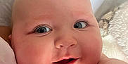 Harrison joined the competition — help win amazing prizes! baby, infant, face, smile, eyes, cheeks, skin, blanket, soft, cute, child, closeup, expression, indoors, healthy, adorable, person, newborn, portrait, resting