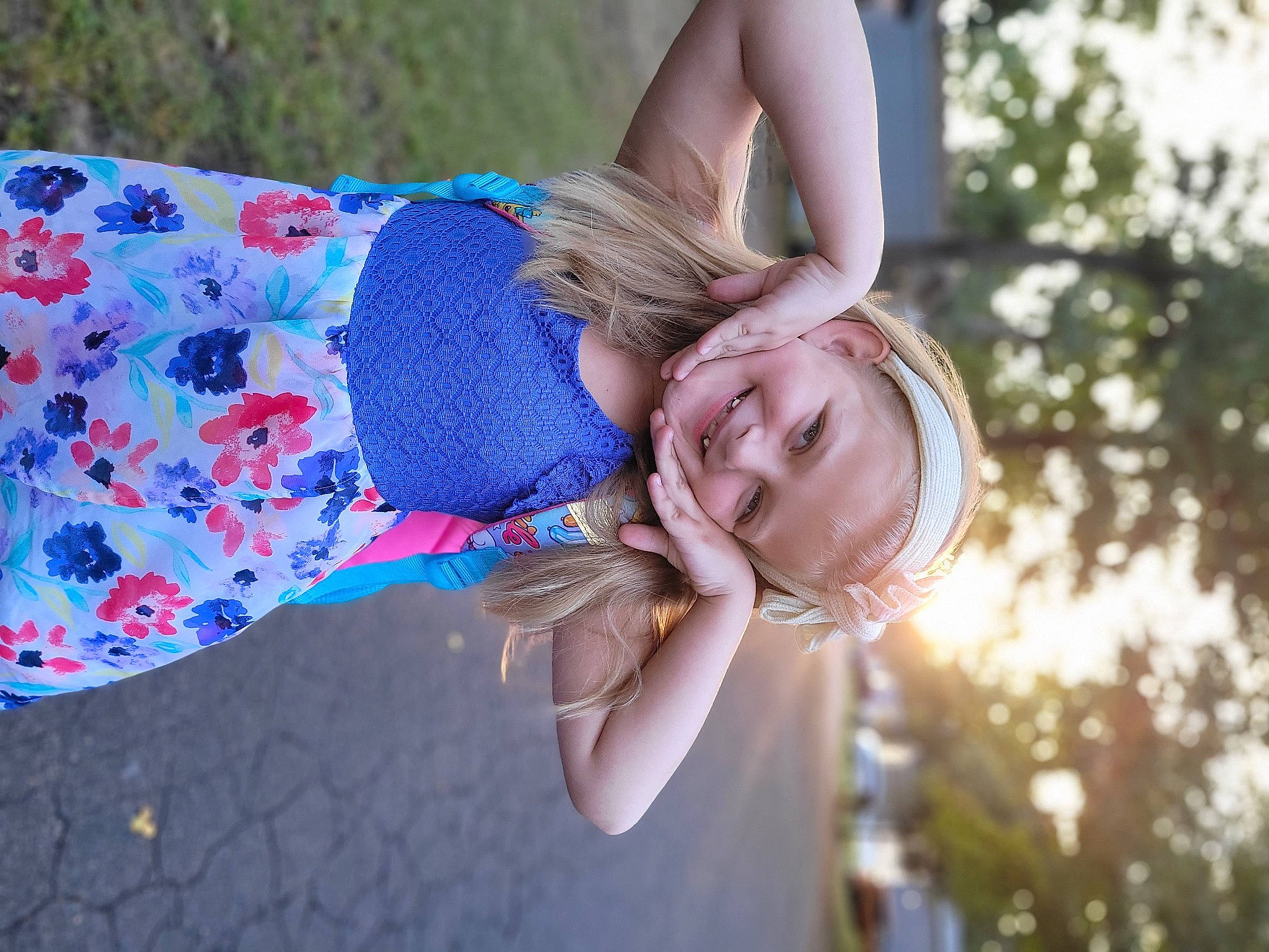 Rebecca is registered to the contest to win money with this photo: blond, child, electric_blue, flash_photography, fun, gesture, grass, grass_family, happy, human_leg, joy, laugh, leisure, people_in_nature, person, plant, portrait_photography, sitting, smile, toddler