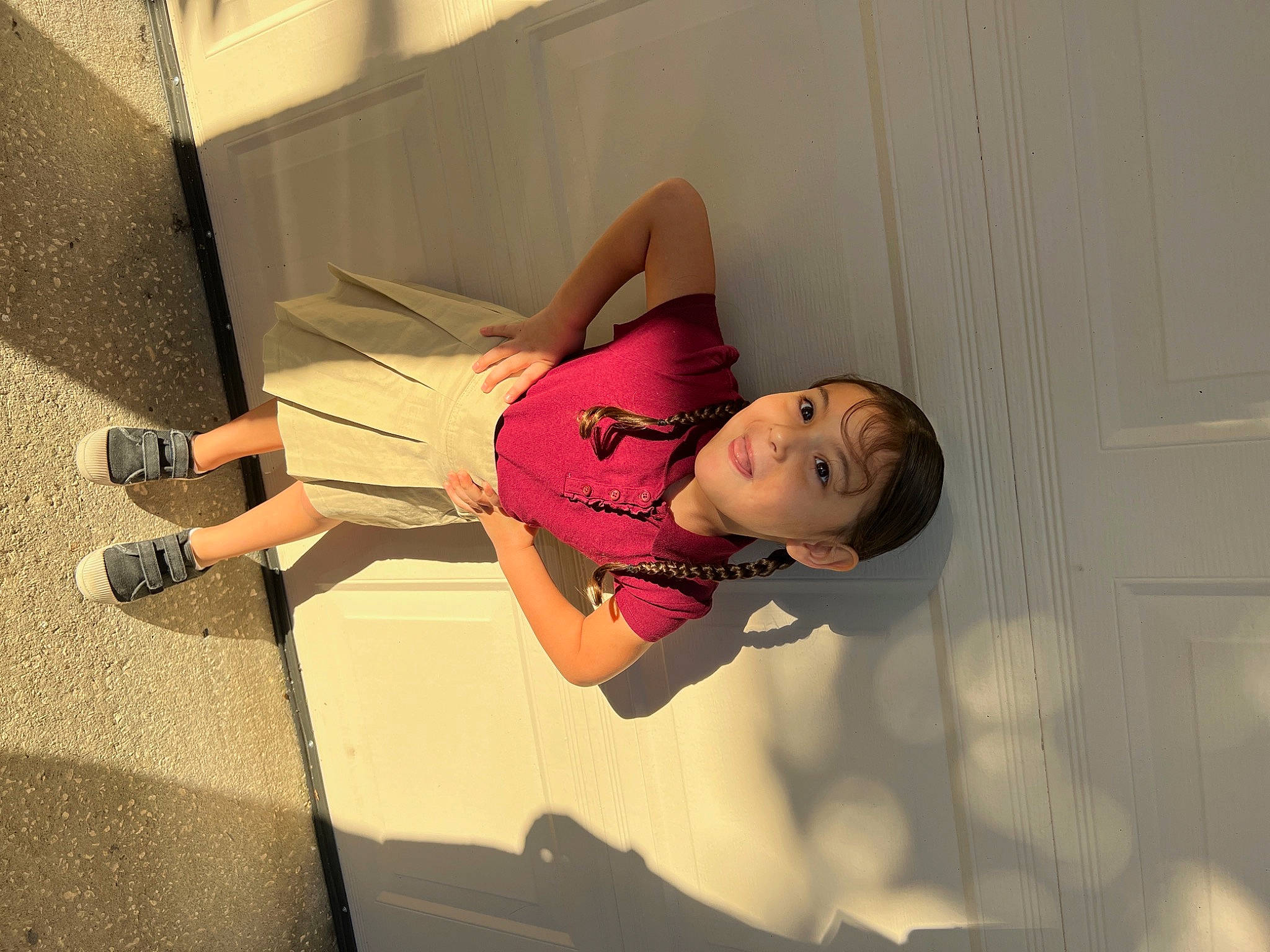 Emma is registered to the contest to win money with this photo: abdomen, child, elbow, eyewear, flooring, fun, human_leg, knee, magenta, person, room, sandal, thigh, toddler, trunk, waist