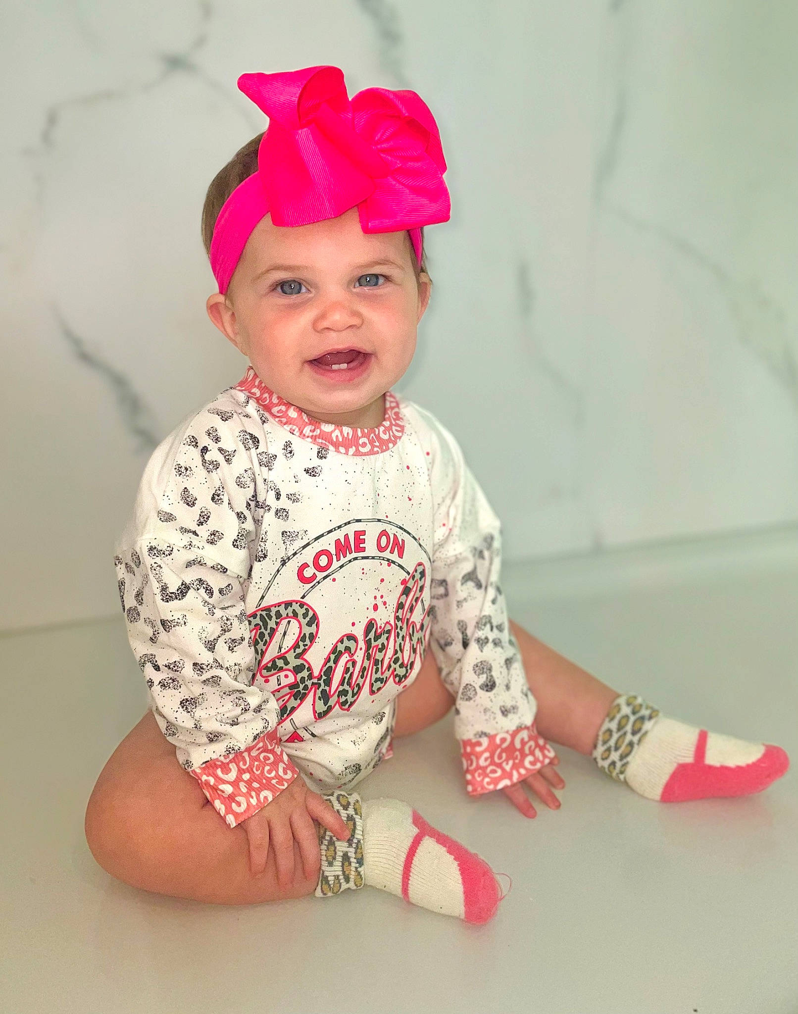 Lilah joined the competition — help win amazing prizes! baby, baby_toddler_clothing, child, clothing, costume_hat, dress, face, happy, headband, headgear, headpiece, headwear, joy, knee, lip, lipstick, neck, person, pink, sleeve