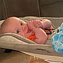 Emrick joined the competition — help win amazing prizes! baby, infant, cushion, blanket, bottle, hand, face, eyes, orange_clothing, indoor, carpet, seat, comfort, child, cute, closeup, portrait, relaxing, baby_gadget, soft