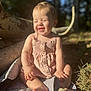 baby, child, smiling, outdoor, sunlight, blanket, nature, grass, tree_trunk, happy, skin, barefoot, infant, person, summer, cute, sitting, daylight, young_child, clothing