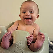Carter is registered to the contest to win money with this photo: baby, child, infant, smiling, happy, sitting, feet, hands, face, skin, bare_skin, seat, baby_seat, indoor, cute, young, expression, portrait, person, toes
