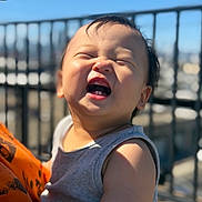 Rocky joined the competition — help win amazing prizes! baby, child, happy, smiling, sunlight, outdoor, fence, cityscape, portrait, person, tank_top, skin, face, expression, daylight, cute, infant, head, photography, human