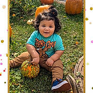 Kross is registered to the contest to win money with this photo: child, toddler, pumpkins, grass, outdoor, scooby_doo, gourd, curly_hair, smiling, fall, autumn, casual_clothing, blue_shoes, greenery, playful, cute, festive, nature, happy, sitting