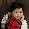 Kross is registered to the contest to win money with this photo: baby, child, smile, face, hair, red_vest, checkered_pattern, white_sleeve, cozy_clothing, cute, portrait, infant, chubby_cheeks, happy, indoor, sitting, warm, soft_texture, closeup, person