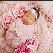 Solymar is registered to the contest to win money with this photo: baby, newborn, pink, blanket, flower, headband, sleeping, soft_texture, fluffy, portrait, cute, infant, wrapped, peaceful, resting, child, toddler, face, cozy, adorable