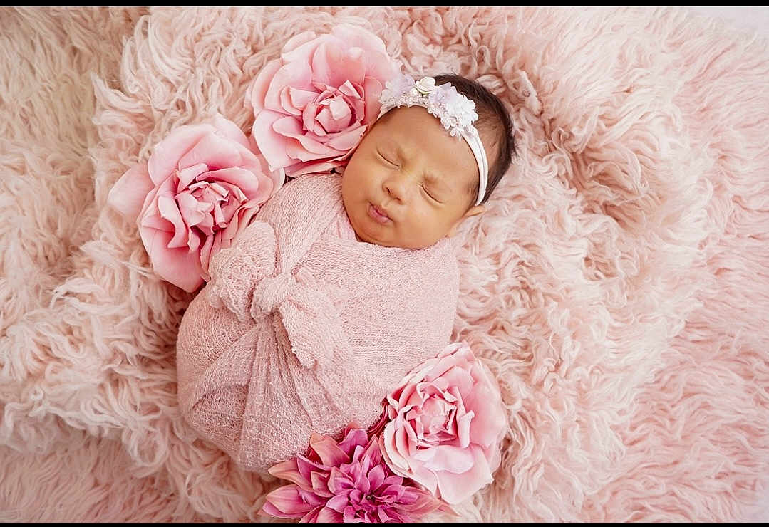 Solymar is registered to the contest to win money with this photo: baby, newborn, pink, blanket, flower, headband, sleeping, soft_texture, fluffy, portrait, cute, infant, wrapped, peaceful, resting, child, toddler, face, cozy, adorable