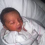 Noah joined the competition — help win amazing prizes! baby, newborn, infant, sleeping, swaddle, blanket, hospital_blanket, pillow, portrait, close_up, cute, peaceful, tiny_hand, clothing, bedding, bed, person, newborn_unit, soft_skin, resting