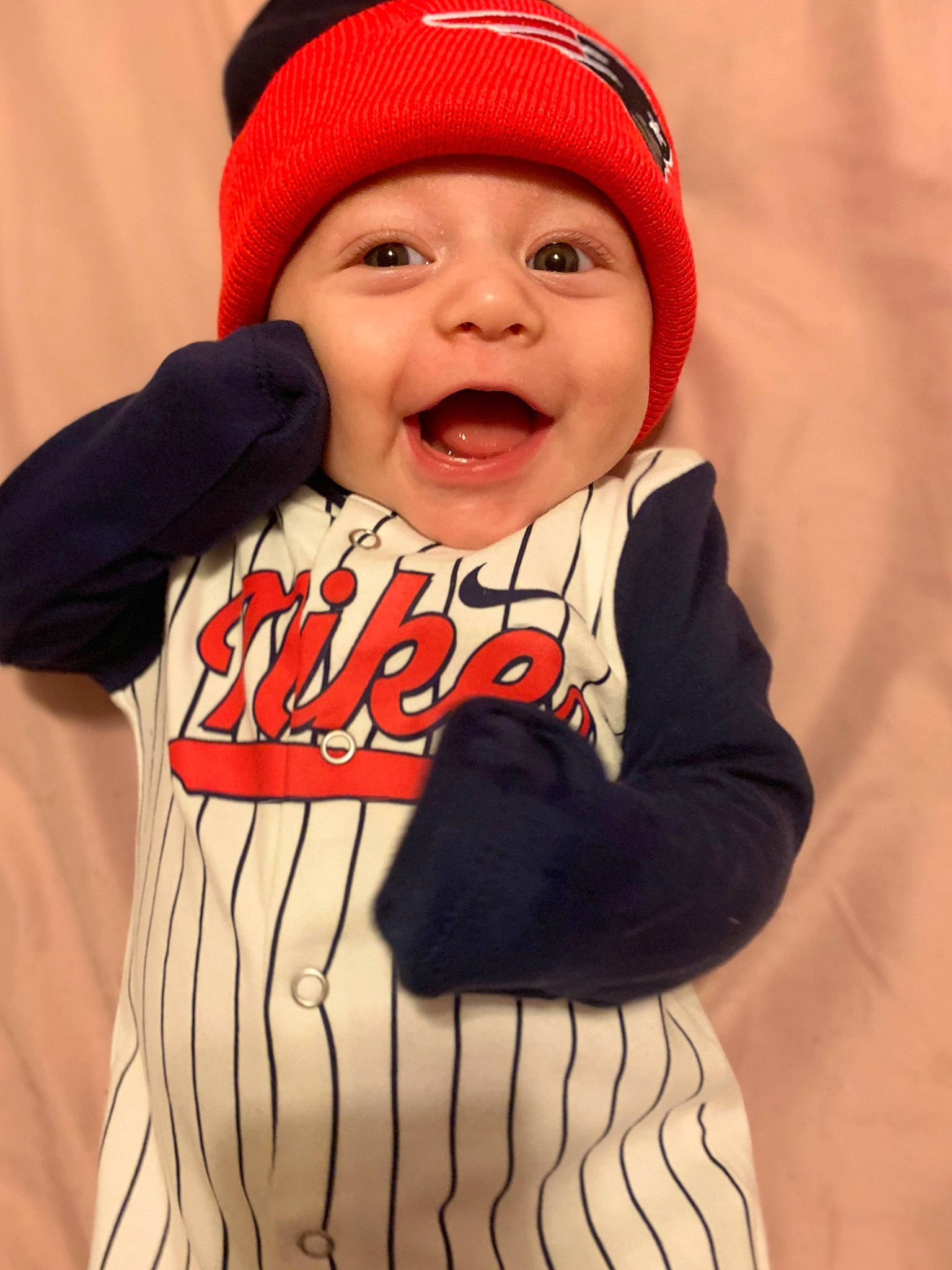 Ezrah joined the competition — help win amazing prizes! baby, beanie, cap, cheek, child, cool, facial_expression, fashion_accessory, fun, happy, headgear, headwear, knit_cap, laugh, person, product, red, sleeve, smile, t_shirt