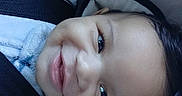 Soldier is registered to the contest to win money with this photo: baby, smile, car_seat, child, blue_clothing, infant, face, seatbelt, warning_label, happy, young_child, safety, portrait, cute, indoors, person, head, closeup, cozy, drool