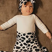 Allison is registered to the contest to win money with this photo: art, baby, baby_toddler_clothing, child, costume, costume_hat, fashion, fashion_accessory, fashion_design, flooring, fur, headband, headpiece, outerwear, pattern, sleeve, textile, toddler, vintage_clothing, white