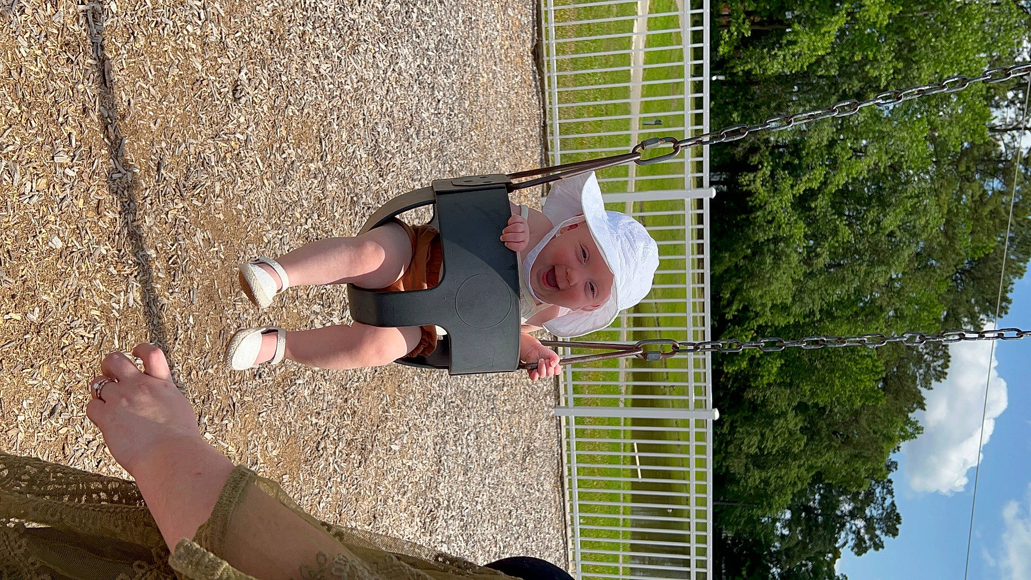 Emberlyn joined the competition — help win amazing prizes! arm, foot, fun, grass, green, hand, headwear, human_leg, knee, leisure, mesh, people_in_nature, person, plant, shadow, sky, smile, soil, thigh, toddler