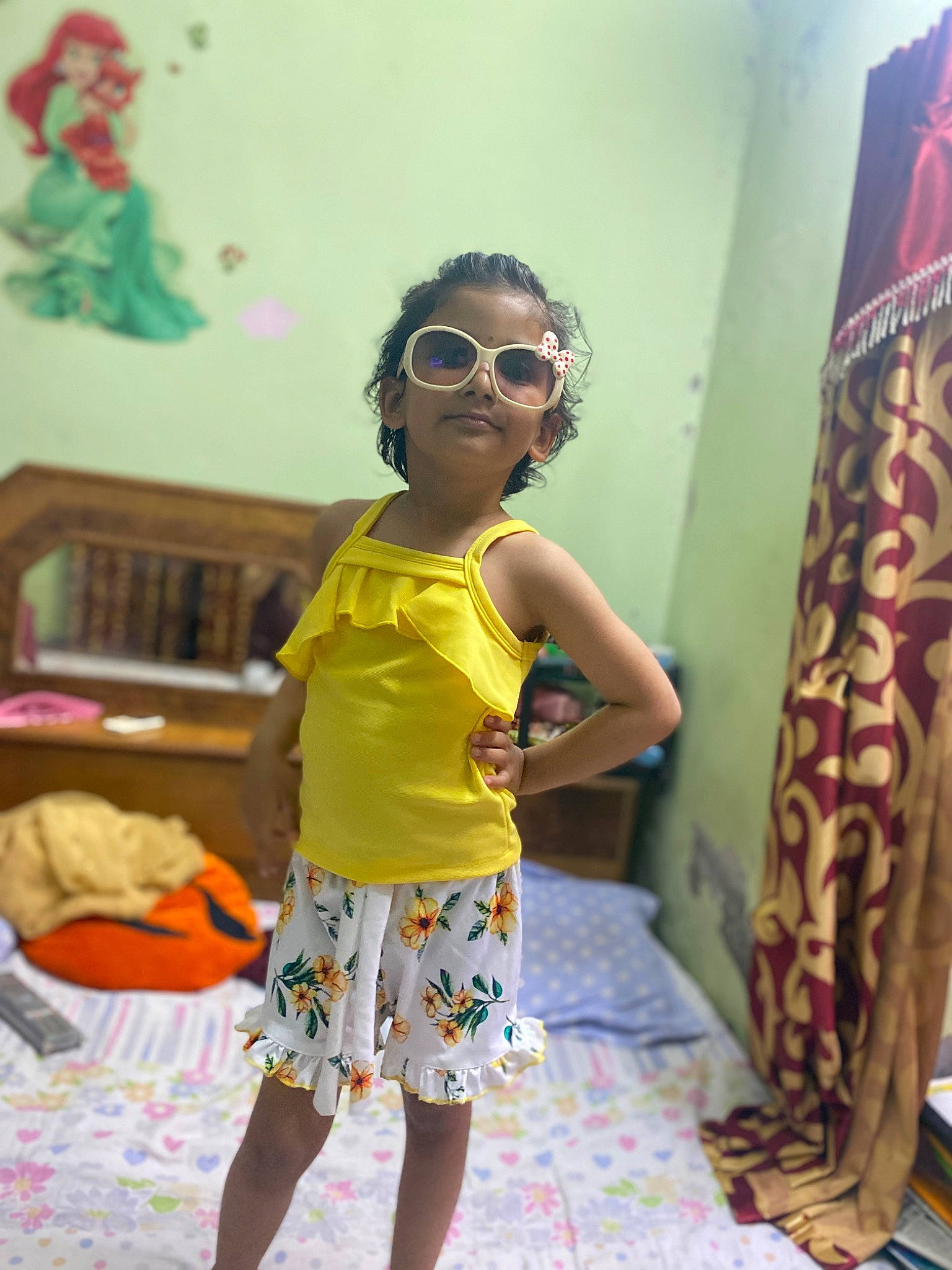 Seerat is registered to the contest to win money with this photo: child, event, eyewear, fashion_design, fun, glasses, goggles, hairstyle, happy, human_leg, joy, leisure, pattern, person, shorts, sleeve, smile, standing, sunglasses, toddler