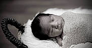 Ezra is registered to the contest to win money with this photo: baby, basket, black_and_white, blanket, child, closeup, cozy, cute, face, head, infant, knitted, newborn, peaceful, portrait, resting, sleeping, soft, texture, wrapped