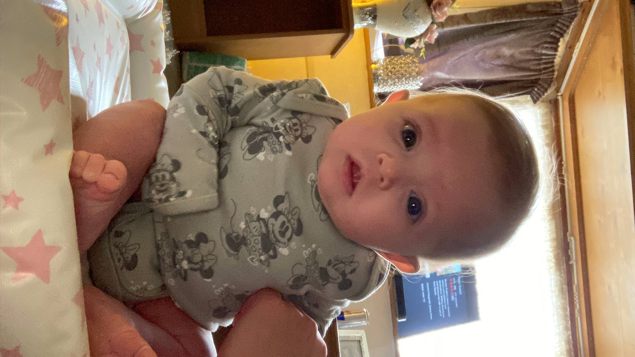 Blossom is registered to the contest to win money with this photo: baby, baby_toddler_clothing, cheek, chest, child, ear, eye, eyebrow, eyelash, finger, happy, iris, lip, mouth, nose, person, room, skin, smile, thumb