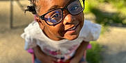 Maria joined the competition — help win amazing prizes! accessories, child, clothing, face, female, footwear, girl, glasses, grass, happy, head, person, photography, plant, portrait, shoe, shorts, sitting, smile, sunglasses