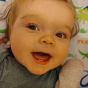 Daxton is registered to the contest to win money with this photo: apparel, baby, background, child, closeup, cute, dinosaur, expression, eyes, fabric, face, hand, happy, infant, mouth, playful, portrait, skin, smile, toy