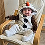 baby, infant, child, snowman_costume, costume, hood, smile, chair, wooden_armchair, indoor, plush, onesie, feet, hands, happy, portrait, nursery, flooring, fabric, cute