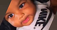 Tyjae is registered to the contest to win money with this photo: baby, child, face, smile, nike, clothing, infant, cute, portrait, person, happy, indoors, apparel, young, expression, head, skin, eyes, toddler, sitting