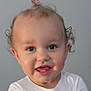 Zo'E joined the competition — help win amazing prizes! toddler, child, smiling, curly_hair, pink_hair_tie, white_shirt, unicorn_print, baby_teeth, face, portrait, happy, indoors, cute, young_child, person, head, eyes, mouth, skin, expression