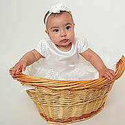 Janelle is registered to the contest to win money with this photo: accessories, baby, basket, clothing, dress, face, fun, hardwood, hat, head, headband, leisureactivities, newborn, person, photography, picnic, portrait, sitting, wood, woven