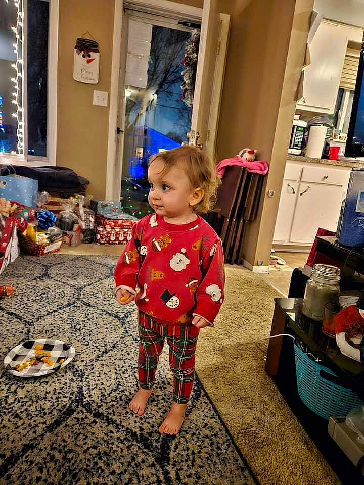 Mya is registered to the contest to win money with this photo: baby, baby_toddler_clothing, carpet, child, door, event, floor, flooring, fun, happy, holiday, living_room, pattern, person, play, room, sidewalk, sitting, standing, toddler