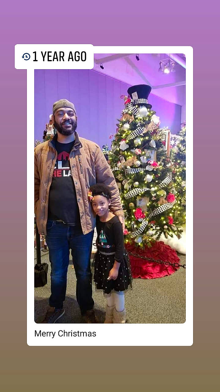 Caleah is registered to the contest to win money with this photo: adaptation, beard, christmas, christmas_decoration, christmas_eve, christmas_ornament, christmas_tree, conifer, event, evergreen, happy, headwear, holiday, holiday_ornament, jacket, joy, magenta, ornament, person, room